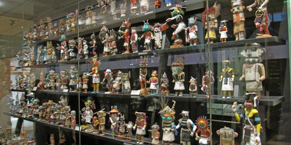Kachina dolls behind glass cases at the Phoenix Heard Museum of Native Cultures and Art.