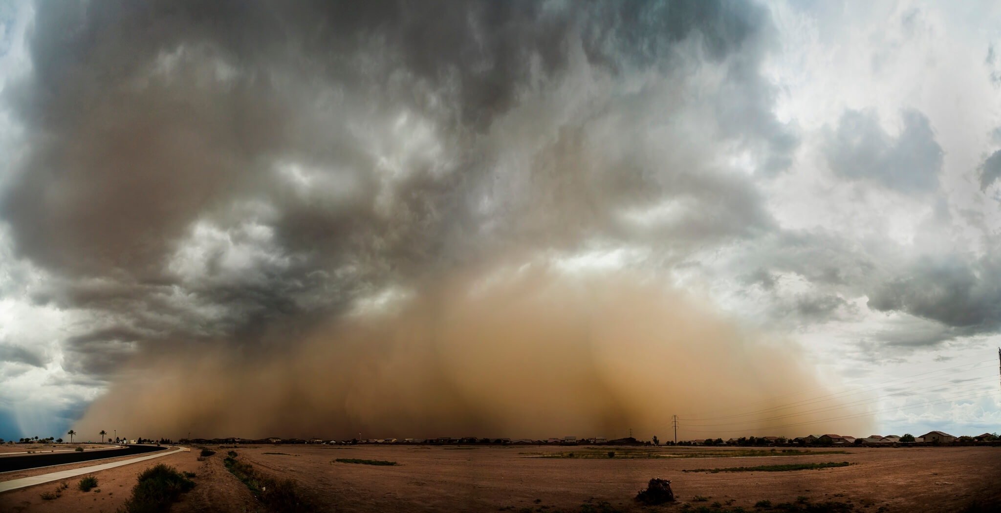 A haboob blowing over the Arizona desert highway.
Flickr User Brock Whittaker Photography