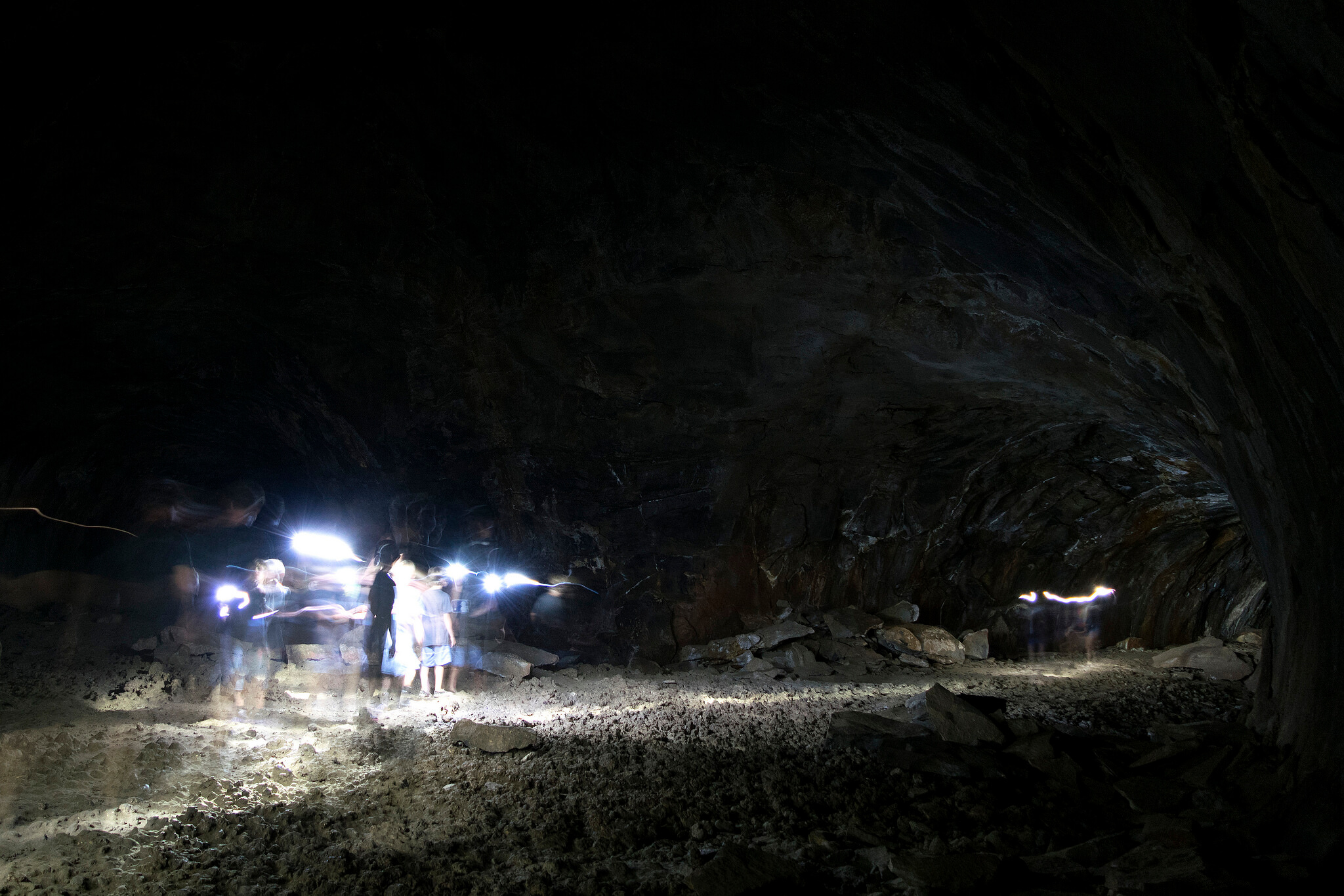 Interior of the Lava River Cave in Arizona. People are spelunking with artificial lighting.
Flickr USer Nicholas Schnur