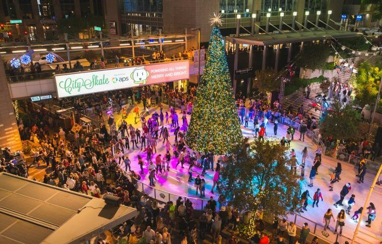 Ice skaters skate around the Christmas tree in downtown Phoenix, Arizona at CitySkate.