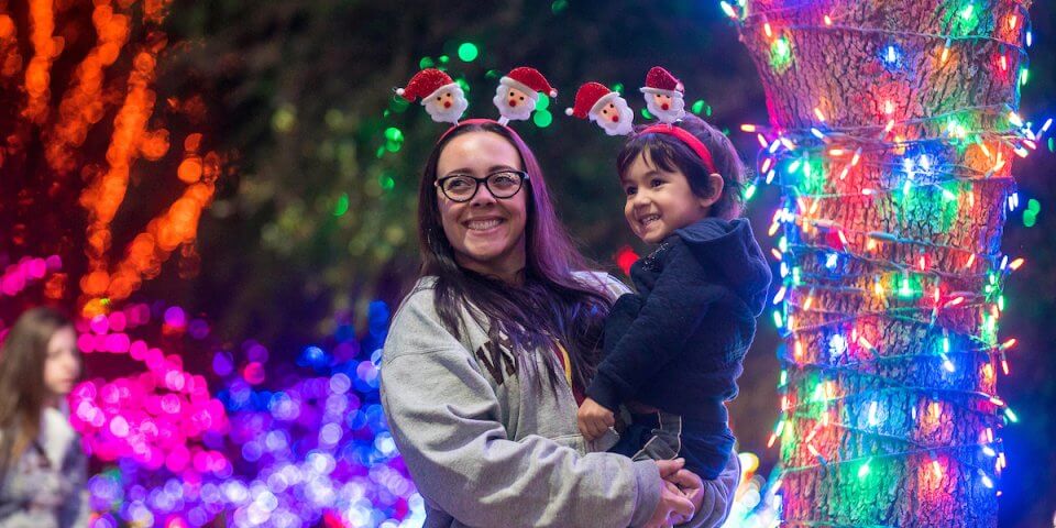 A mother and daughter enjoy lights at Glow Wild at the Phoenix Zoo.