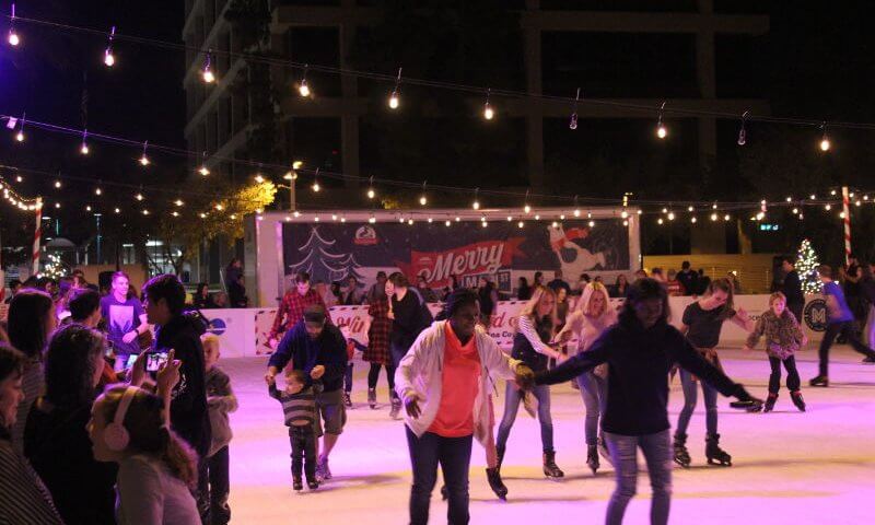 People enjoying themselves as they ice skate at Winter Wonderland Ice Rink in downtown Mesa, Arizona.
