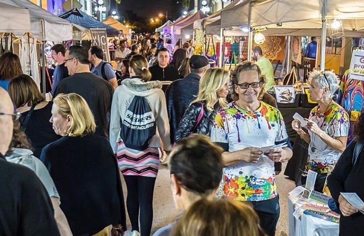Night time shot of a busy moment at the Downtown Hollywood Art Walk in Florida.