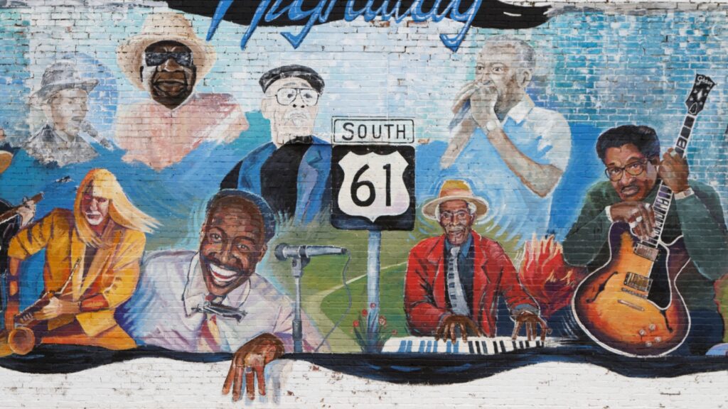 A mural depicting various blues musicians and a "SOUTH 61" sign, referencing Highway 61, known as the "Blues Highway" and its connection to the roots of the blues in the Mississippi Delta. 