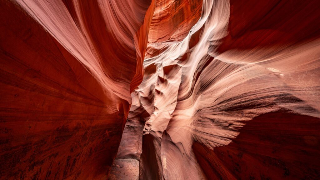 Cardiac slot canyon in Page Arizona highlights the narrow passageway and amazing, glowing light and intricate patterns that form over millions of years from the combination of water and sediment flow.
