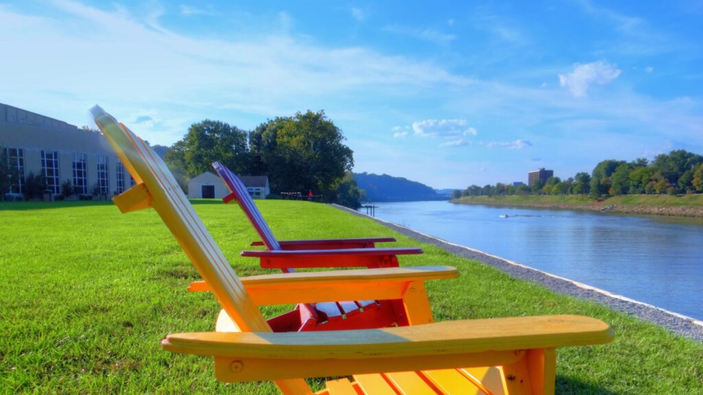 Colorful chairs overlooking the Kanawha River on a clear day.