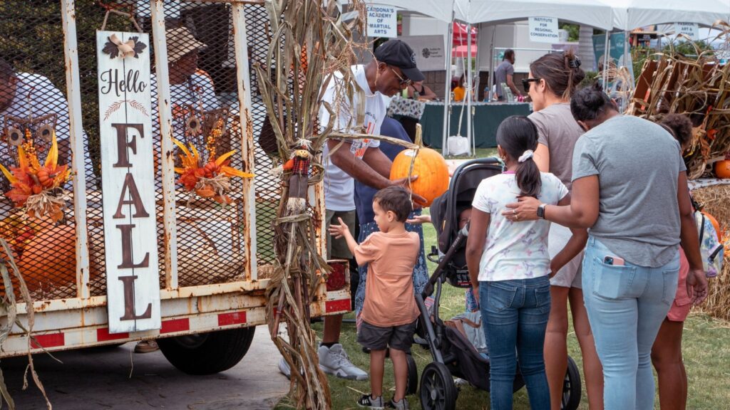 Pumpkin distribution to the families at fall festival.