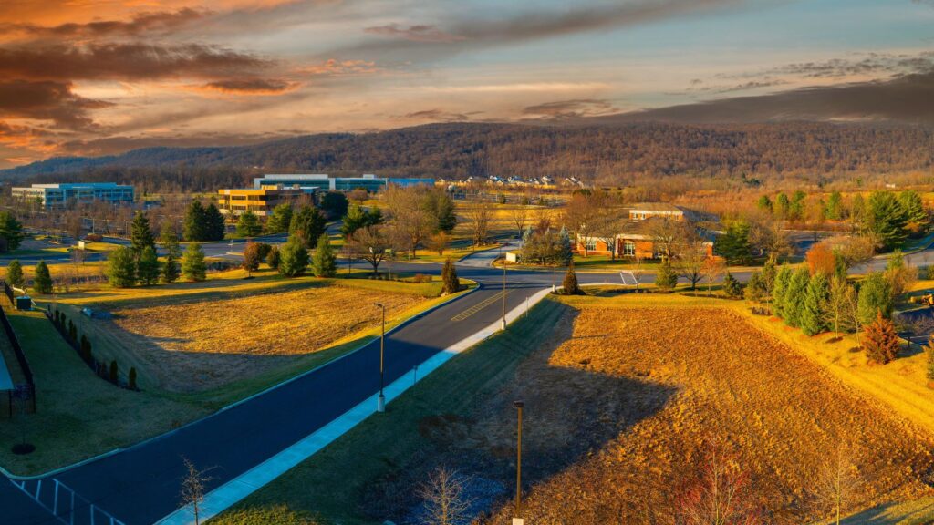 Tranquil spring sunrise landscape and dramatic cloudscape over the Center Valley, buildings, and street in Allentown, Pennsylvania, USA.