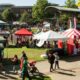 Suwanee, GA USA - September 21, 2019: Wide shot of people milling about the vendor tents, displays and games at the Suwanee Fest event on September 21, 2019 in Suwanee, GA.