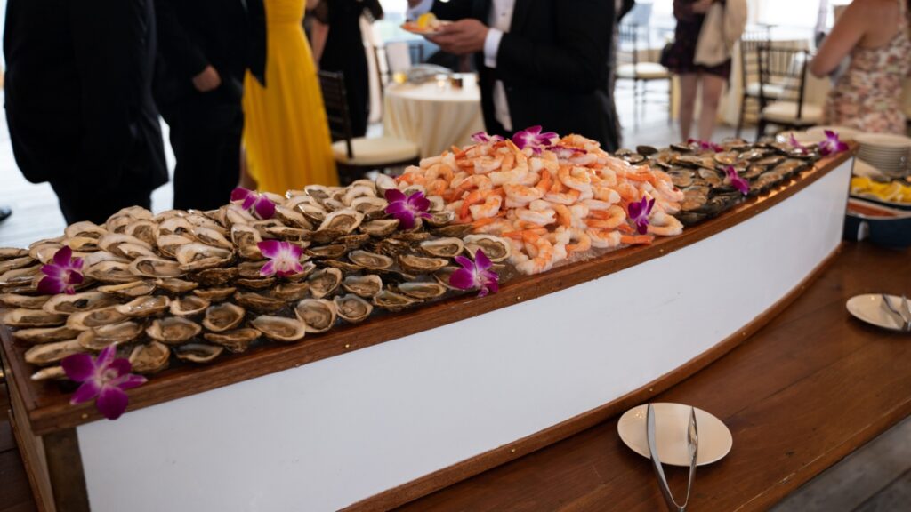 Shrimp and oysters served on ice in a wooden boat display