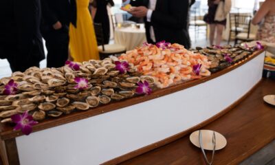Shrimp and oysters served on ice in a wooden boat display