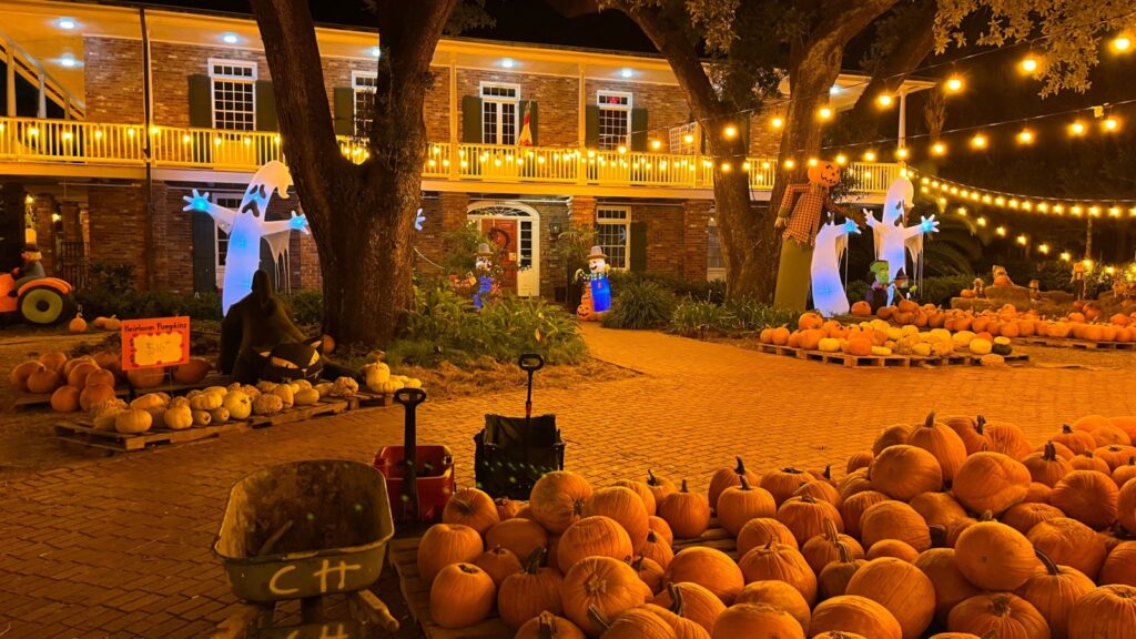 New Orleans house halloween decoration, pumpkins, ghosts, black cat. Horizontal picture of scary fun halloween decorations.
